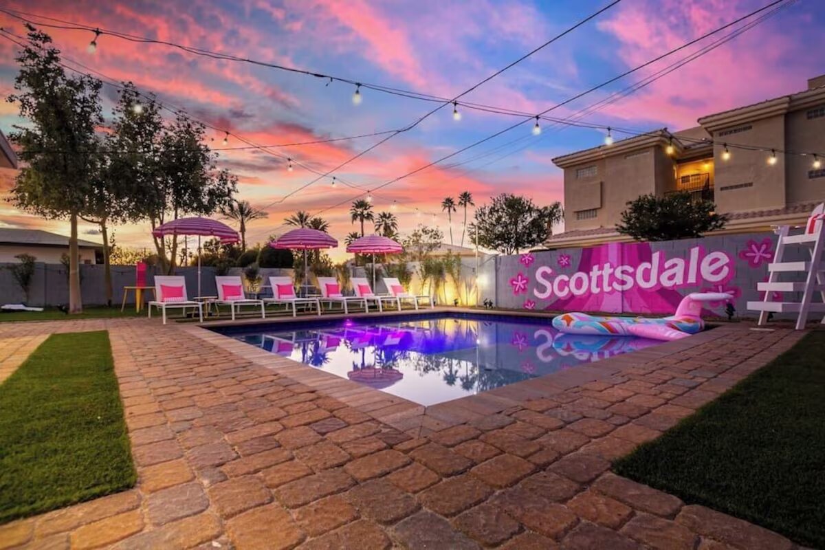 Pink-themed bachelorette pool at sunset with Scottsdale Barbie-style sign