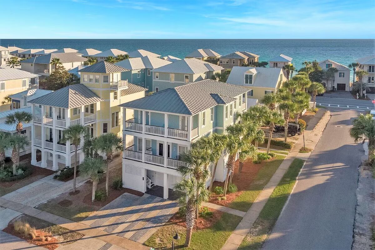 Aerial view of pastel beach houses on 30A Florida with the Gulf of Mexico in the background